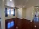 Bright bedroom with dark hardwood floors, neutral paint, and a ceiling fan for optimal comfort at 7481 Benlomond Ave, Las Vegas, NV 89179