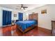 Comfortable bedroom with ceiling fan, hardwood floors, and a decorative wood headboard at 7481 Benlomond Ave, Las Vegas, NV 89179