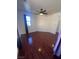 Bright bedroom featuring laminate flooring, a ceiling fan, and natural lighting at 7481 Benlomond Ave, Las Vegas, NV 89179