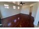 Neutral bedroom with hardwood floors, a ceiling fan and white trim work at 7481 Benlomond Ave, Las Vegas, NV 89179
