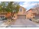 Two-story house with neutral color scheme and landscaped front yard at 7481 Benlomond Ave, Las Vegas, NV 89179