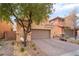 Two-story house with neutral color scheme and landscaped front yard at 7481 Benlomond Ave, Las Vegas, NV 89179