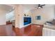 Gathering room with hardwood floors, gray sectional and a media niche at 7481 Benlomond Ave, Las Vegas, NV 89179