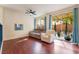 Gathering room with hardwood floors, gray sectional, and access to backyard at 7481 Benlomond Ave, Las Vegas, NV 89179
