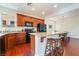 Kitchen features granite countertops, island with seating, and wood cabinets at 7481 Benlomond Ave, Las Vegas, NV 89179