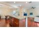 Open kitchen with granite island, hardwood floors, and views to living room at 7481 Benlomond Ave, Las Vegas, NV 89179