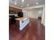 Open concept kitchen with granite counters, dark cabinets, and a spacious center island at 7481 Benlomond Ave, Las Vegas, NV 89179