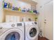 Well-equipped laundry room featuring side-by-side Samsung washer and dryer, and ample storage at 7481 Benlomond Ave, Las Vegas, NV 89179
