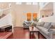 Living room with hardwood floors, gray sofa and a staircase at 7481 Benlomond Ave, Las Vegas, NV 89179