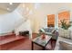 Living room with hardwood floors, gray sofa, and staircase at 7481 Benlomond Ave, Las Vegas, NV 89179