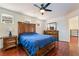 Main bedroom suite boasts hardwood floors, wood furniture and a ceiling fan for added comfort at 7481 Benlomond Ave, Las Vegas, NV 89179