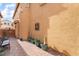 Landscaped side yard with brick pavers and potted plants at 7481 Benlomond Ave, Las Vegas, NV 89179