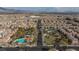 Aerial view of community with pool and surrounding homes at 7660 Fabled Filigree St, Las Vegas, NV 89149