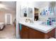 Bathroom with a double sink vanity, adjacent to bedroom at 7660 Fabled Filigree St, Las Vegas, NV 89149