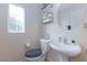 Clean and modern bathroom with pedestal sink and updated toilet at 7660 Fabled Filigree St, Las Vegas, NV 89149