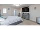 Spacious main bedroom with large TV, dresser, and private door access at 7660 Fabled Filigree St, Las Vegas, NV 89149