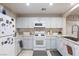 Well-equipped kitchen with white cabinets and gas range at 7660 Fabled Filigree St, Las Vegas, NV 89149