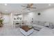 Bright living room with open floor plan, featuring a comfortable sectional sofa and large coffee table at 7660 Fabled Filigree St, Las Vegas, NV 89149