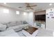 Living room featuring sectional sofa and large TV at 7660 Fabled Filigree St, Las Vegas, NV 89149