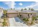 Single-story home with a two-car garage and desert landscaping at 7830 Lyrebird Dr, North Las Vegas, NV 89084