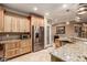 Well-equipped kitchen featuring stainless steel fridge and microwave at 7830 Lyrebird Dr, North Las Vegas, NV 89084