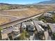 Aerial view of a modern home nestled in the desert hills with a pool and covered patio at 82 Glade Hollow Dr, Las Vegas, NV 89135