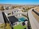 Aerial view showcasing the property's layout, including the pool, backyard, and surrounding neighborhood at 82 Glade Hollow Dr, Las Vegas, NV 89135