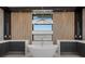 Bright bathroom featuring a soaking tub with a modern light fixture and wood accent wall at 82 Glade Hollow Dr, Las Vegas, NV 89135