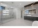 Contemporary bathroom with a glass-enclosed shower, dual vanities, and modern lighting at 82 Glade Hollow Dr, Las Vegas, NV 89135