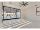 Bright living room with tile floors and sliding glass doors leading to outdoor kitchen at 82 Glade Hollow Dr, Las Vegas, NV 89135