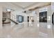 Expansive living room with high ceilings, marble accent wall, and floating staircase at 82 Glade Hollow Dr, Las Vegas, NV 89135