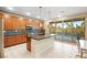 Modern kitchen with island, stainless steel appliances, and view of the pool at 8290 Charleston Peak St, Las Vegas, NV 89166