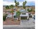 Two-story house, palm trees, and a view of the neighborhood at 881 Stonehenge St, Las Vegas, NV 89110