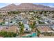 Aerial view showing house, pool, and mountain backdrop at 881 Stonehenge St, Las Vegas, NV 89110