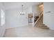 Spacious dining area with a chandelier and view of the living room at 881 Stonehenge St, Las Vegas, NV 89110