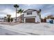 Two-story house with brown garage door and palm trees at 881 Stonehenge St, Las Vegas, NV 89110