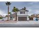 Two-story house with brown garage door and palm trees at 881 Stonehenge St, Las Vegas, NV 89110