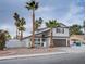 Two-story house with brown garage door and palm trees at 881 Stonehenge St, Las Vegas, NV 89110