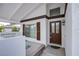 Covered porch with brown door and white walls at 881 Stonehenge St, Las Vegas, NV 89110