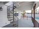 Covered patio with spiral staircase and pool view at 881 Stonehenge St, Las Vegas, NV 89110