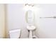 Small bathroom with pedestal sink, toilet and oval mirror at 989 Crescent Falls St, Henderson, NV 89011