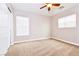 Bright bedroom with carpet flooring, neutral walls, and two windows with blinds at 989 Crescent Falls St, Henderson, NV 89011