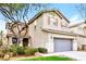 Two-story house with attached garage, landscaping, and mature tree at 989 Crescent Falls St, Henderson, NV 89011
