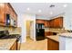 Kitchen with granite countertops and wood cabinets at 989 Crescent Falls St, Henderson, NV 89011