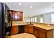 Kitchen with granite countertops, wood cabinets and island at 989 Crescent Falls St, Henderson, NV 89011