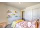 Well-lit bedroom with colorful bookshelves and a comfy bed at 10164 Mulberry Ridge St # 42, Las Vegas, NV 89141