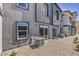 Rear exterior view showing a gravel backyard and AC units at 10164 Mulberry Ridge St # 42, Las Vegas, NV 89141