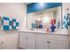 Bathroom with white vanity, mirror, and blue accents at 10168 Mulberry Ridge St # 43, Las Vegas, NV 89141