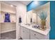 Bathroom with vanity, walk-in closet, and blue accent wall at 10168 Mulberry Ridge St # 43, Las Vegas, NV 89141