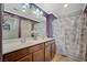 Bathroom with double vanity, purple walls, and marble shower curtain at 10191 Cougar Crossing St, Las Vegas, NV 89178